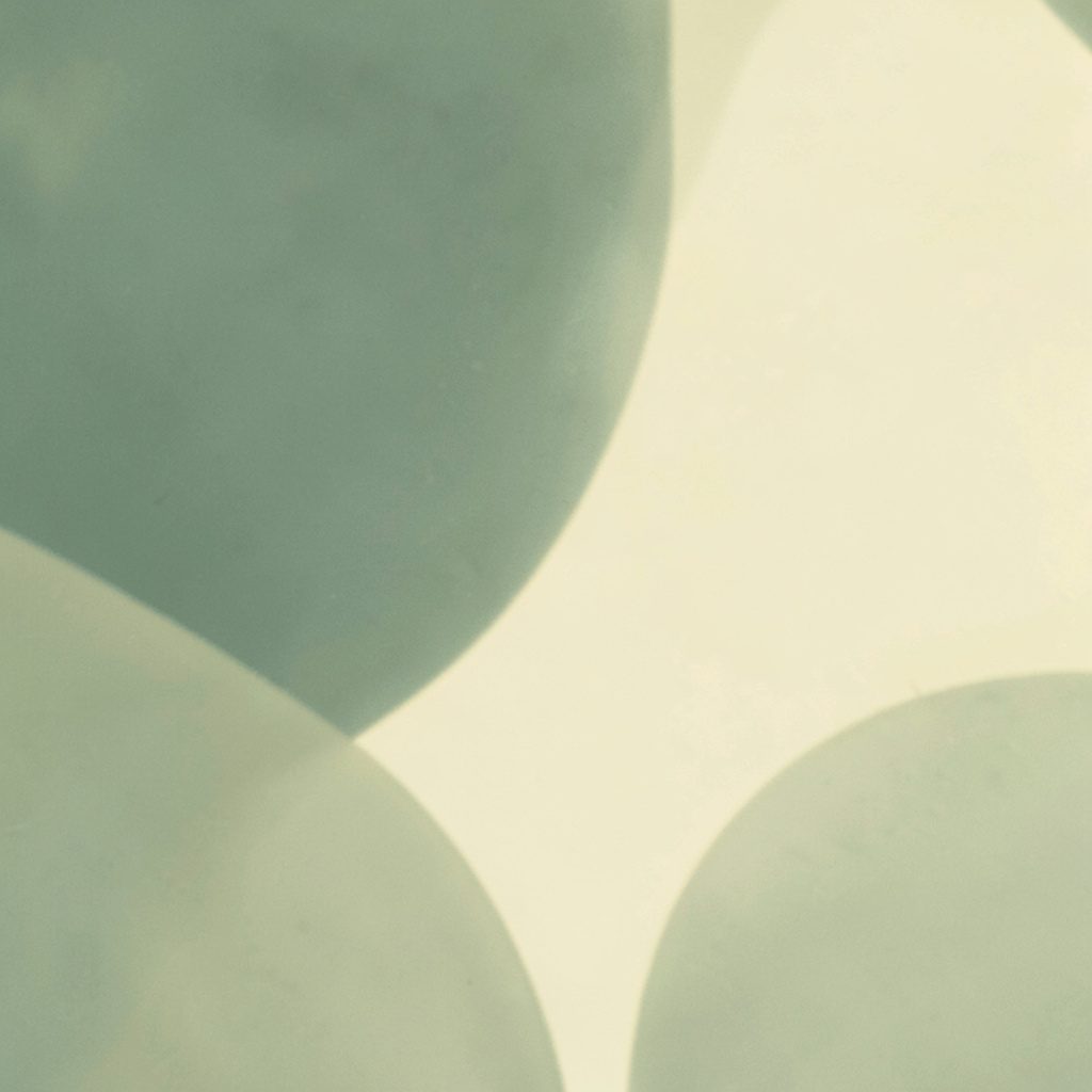 A soft abstract composition in sage green and cream with gentle organic shapes, duotone photograph